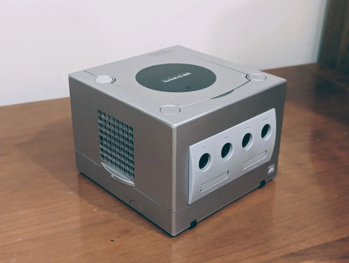 Accessories image of Unboxing or flat lay photo showing the Nintendo GameCube console alongside its included accessories and cables